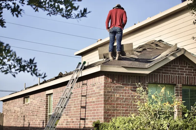 Professional roofer working on a residential roof in Stronghold